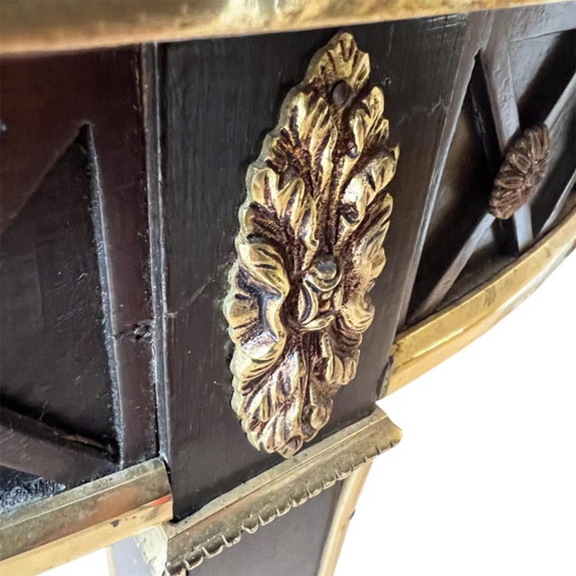 This highly decorative centre table was made in France in the 1950s to a neo classical design and in the style of the...