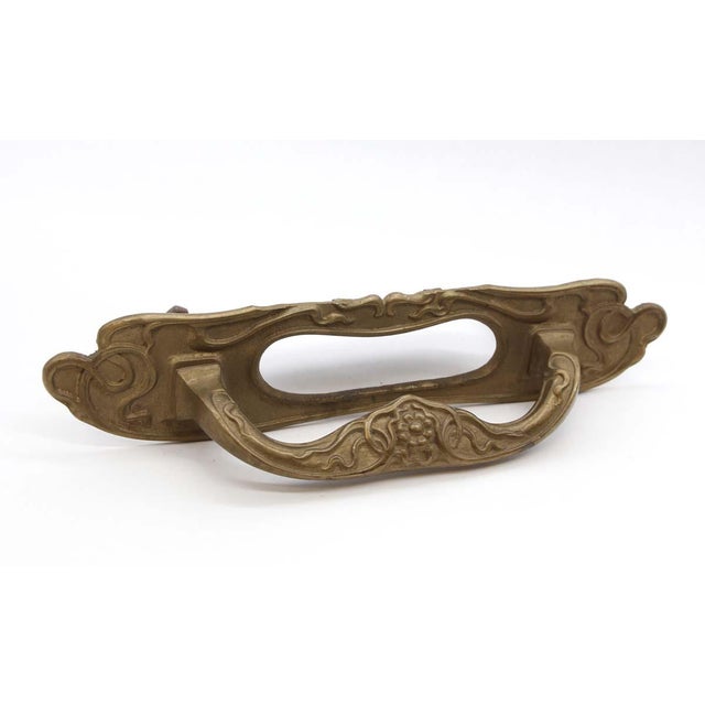 Antique mail slot door pull with an Art Nouveau design and a patina brass finish. Good condition with appropriate wear...