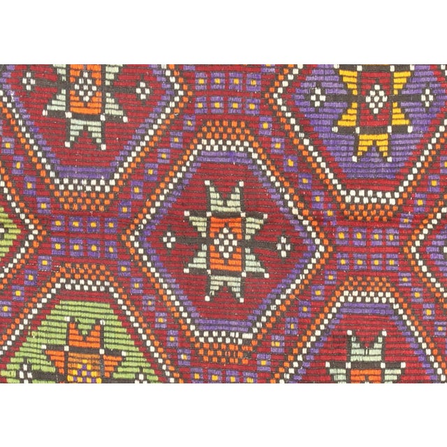 This Vintage Turkish Kilim was hand-woven in the Oushak region of Turkey using wool on a wool foundation. At a size of...