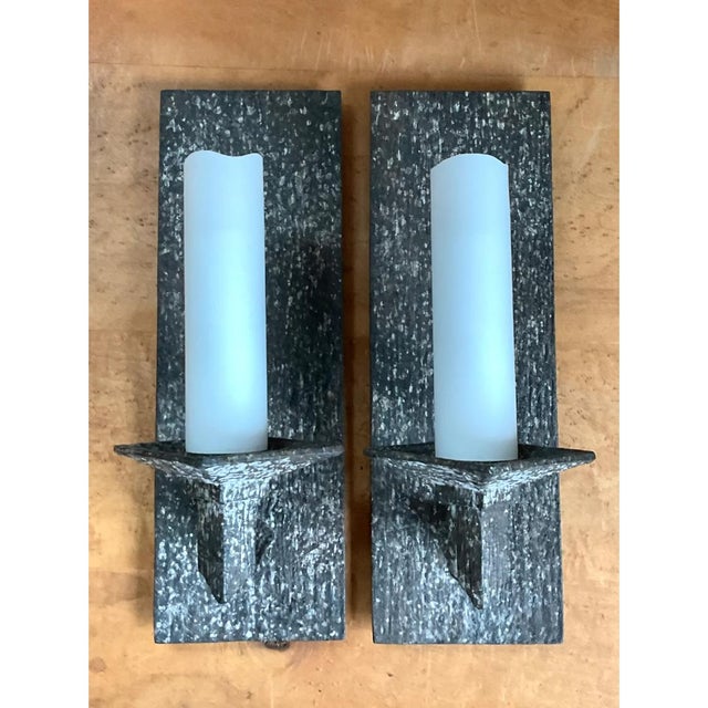 Exuding a compelling blend of Mid-Century Modern and Industrial Brutalist aesthetics, this pair of vintage wall sconces...