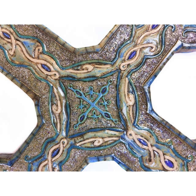 "Intreccio di luce" (Weaving of Light) is a unique Raku ceramic work, entirely hand-molded and decorated by artist...