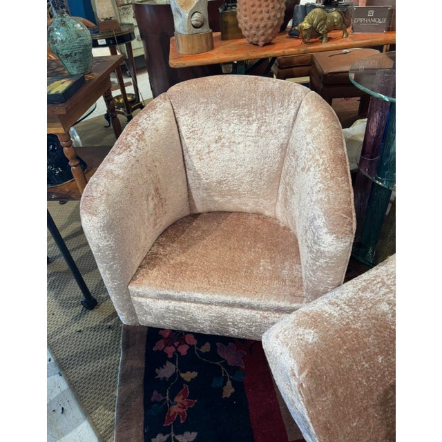 Pair of vintage swivel club chairs newly reupholstered in an ultra-soft blush crushed velvet. Featuring a clean rounded...