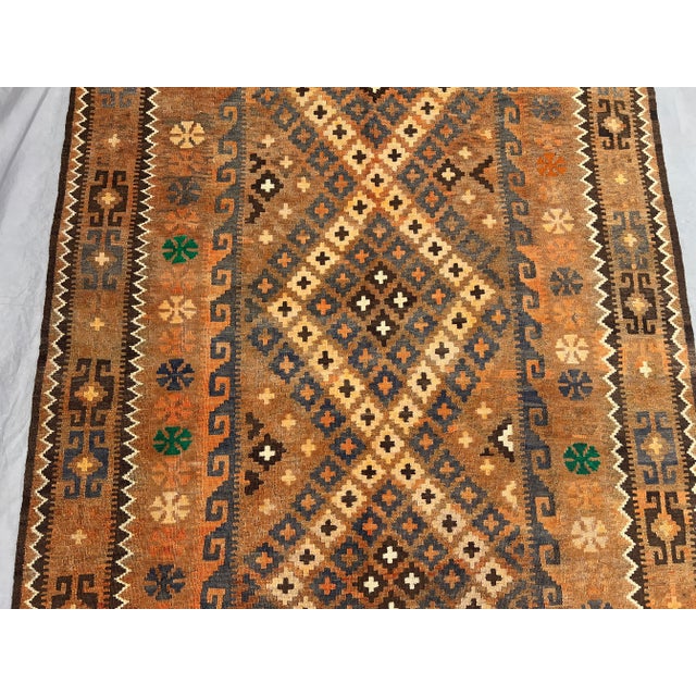 This antique Afghan Ghelmori hand-woven kilim rug is a true masterpiece of tribal artistry and color harmony. Carefully...
