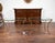 A pair of gilt bronze console tables from the mid-20th century, with faux bois motifs, glass tops and cross stretchers....