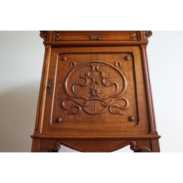 Solid oak cabinet / dresser / bedside table with beautiful art nouveau / art nouveau carvings with the typical whiplash...
