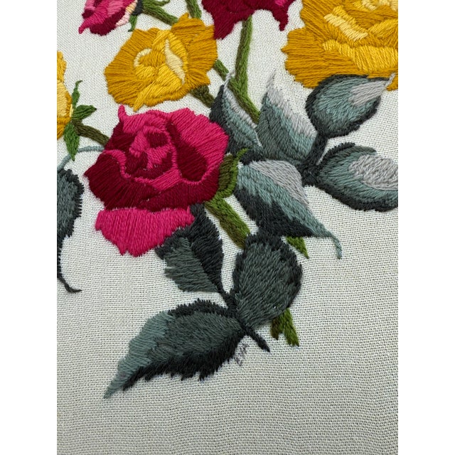 Offering a sweet hand-stitched vintage needlepoint, crewel embroidery with original vintage framing. Signed by textile...