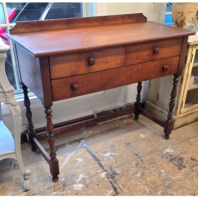 Early American wooden desk. Very charming piece. It has 3 working drawers. Traditional spindle legs. The wood had that...