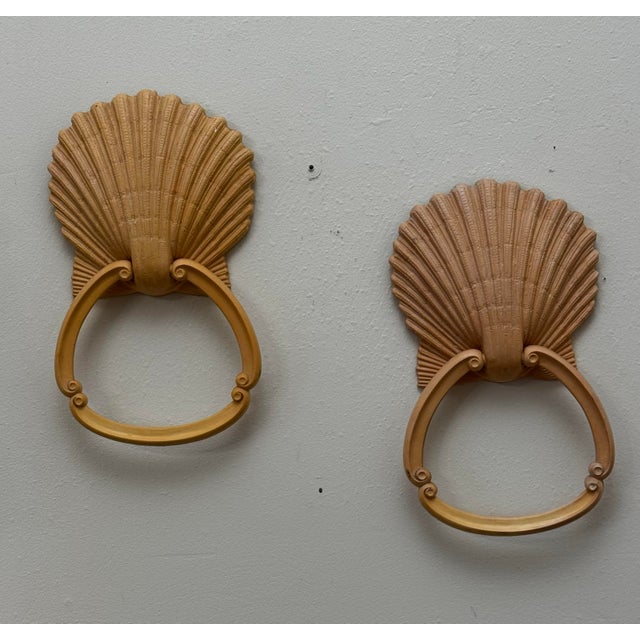 The pair of towel holders feature a distinct scallop shell backplate integrated with a stylized towel ring decorated with...