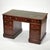A nicely proportioned three-piece Georgian kneehole desk with a green tooled leather writing surface and gilt embossed...