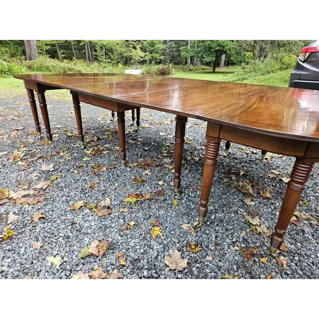 Early 19th Century English Regency Period Dining Table. Three sections with two original leaves. Extremely well-figured...