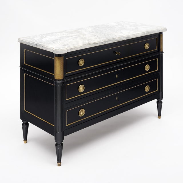 A refined French commode secrétaire in the Louis XVI style, finished in a lustrous ebonized French polish. The upper...