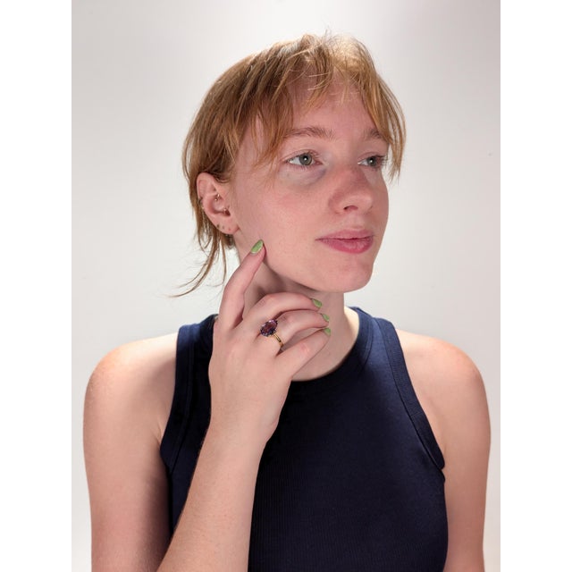 A fine estate cocktail ring. In 14k yellow gold. Claw set with a large pear cut amethyst gemstone in a high-set setting....