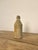 Antique glazed stoneware ginger beer bottle, dating from the 19th century. The bottle features a primitive salt-glazed...
