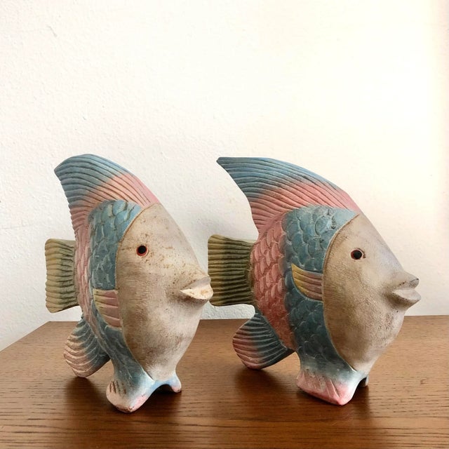 A pair of Colorful Hand Carved Wood Fish Figurines. Circa 1980s. Features incised fish scales and fin details in pastel...