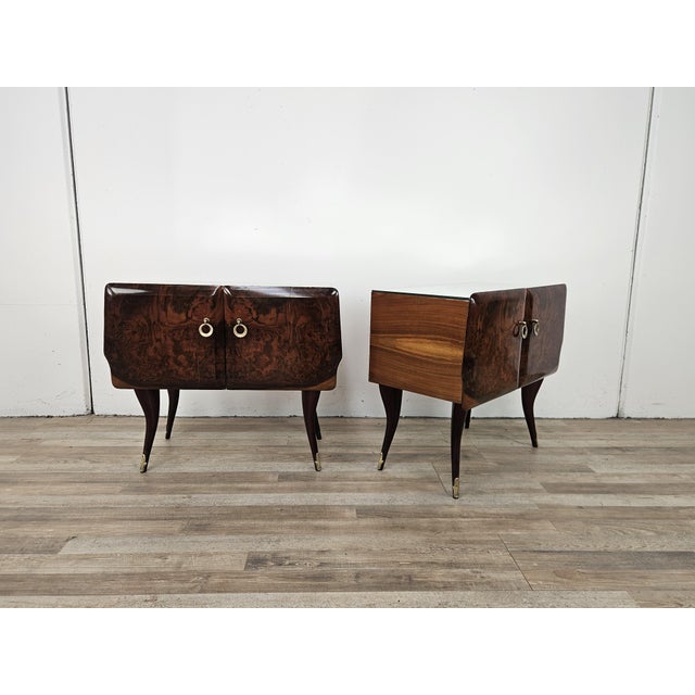 Elegant pair of 1950s mahogany nightstands, featuring a beautiful burl grain that lends depth and sophistication. The...