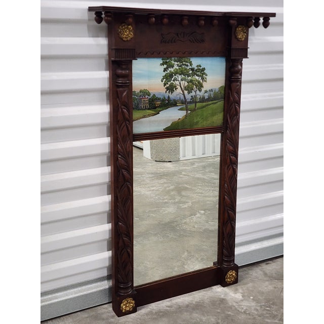 A beautiful exemple of an early 19th century Federal style mahagony carved wood trumeau mirror with reverse painting....