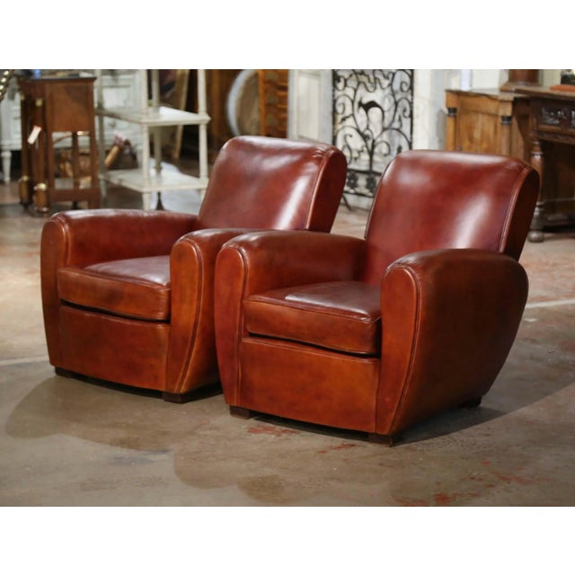 These classic, antique Art Deco club chairs were crafted in France, circa 1920. The stately chairs sit on square feet, and...