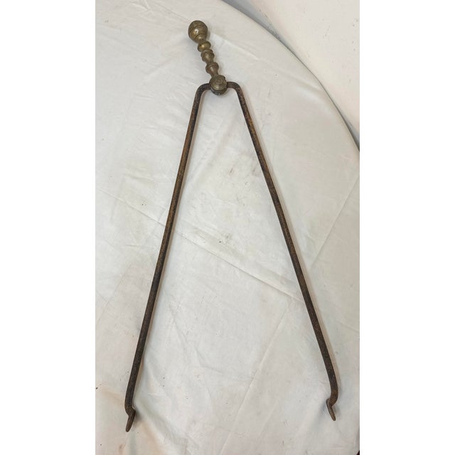 Up for sale is a pair of rare antique 18th century wrought iron and brass English fireplace tongs. The arms are wrought by...