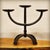 Three-light wrought iron candelabra, handcrafted using the hot-forging technique. The partially twisted central stem rests...