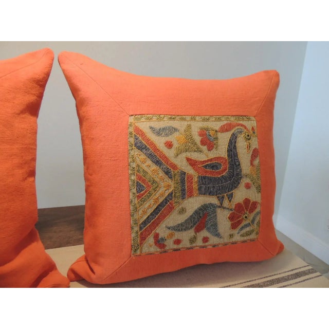 Set of ‘2’ Bright Orange Indian Suzani Square Decorative Pillows Pillows depicting colorful peacocks and woven flowers....