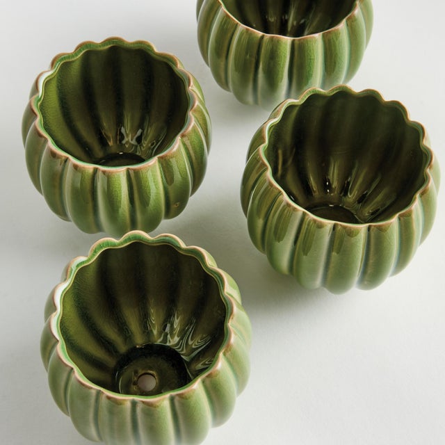 With rounded form, petallike details and thickly applied glaze, this natureinspired set four mini pots is extraordinary....