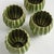 With rounded form, petallike details and thickly applied glaze, this natureinspired set four mini pots is extraordinary....