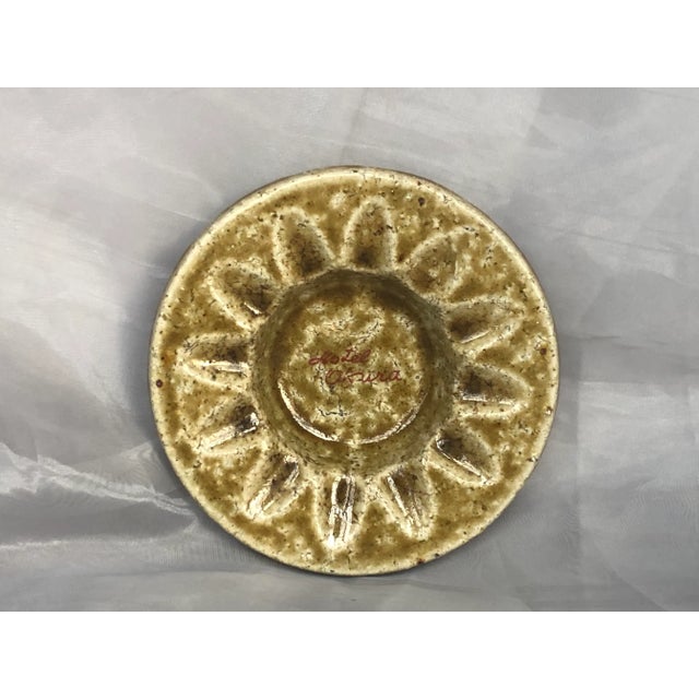 Evocative of the sun, this vintage souvenir pottery ashtray from the Hotel Okura in Tokyo, Japan in the Brutalist style...