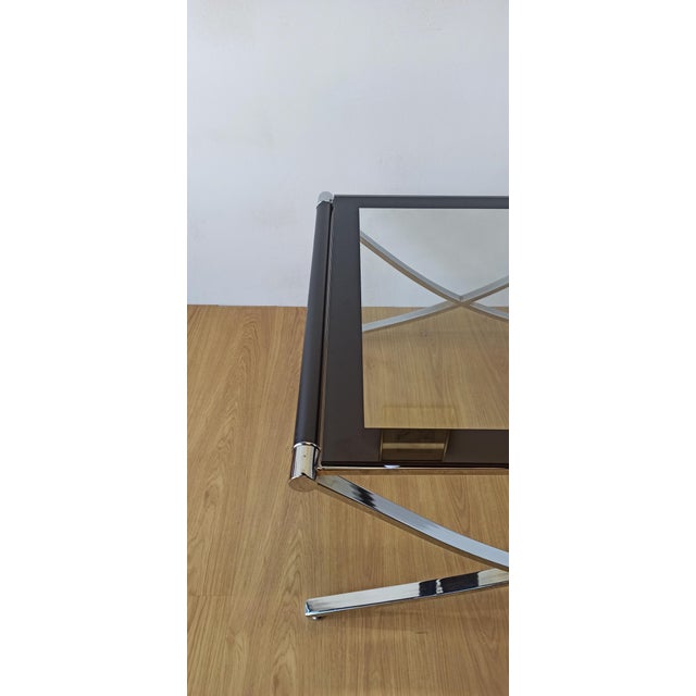 Elegant coffee table designed in the 70s. A straight, light line with its criss-cross base. High-quality design with a...