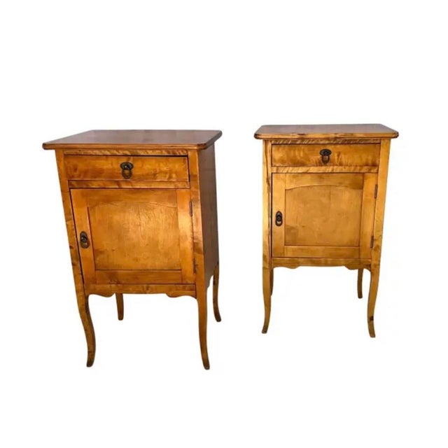 A Pair of French Provincial Nightstands. This charming pair of nightstands are have a warm honey-amber patina with...