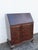This Secretary Desk is made out of wood, solid wood, mahogany, and veneer. It was made by Pray's Furniture and it is...