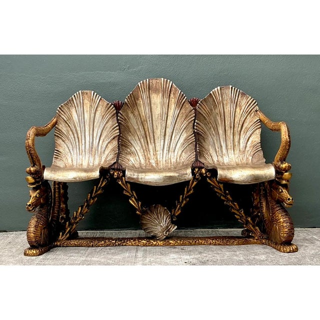 This vintage Venetian gilt carved grotto bench presents a theatrical, sculptural silhouette, with three sweeping scallop-...