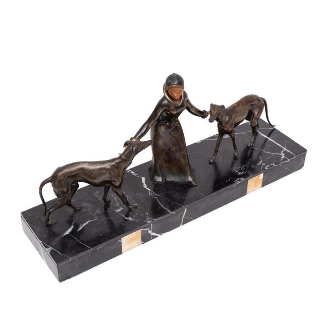 This striking original Art Deco sculpture depicts a graceful woman walking two sleek Borzois,a motif that exemplifies the...