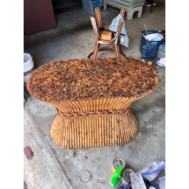 Refurbished McGuire stacked rattan table base with top restored in a faux tortoise shell. This mid century vintage “sheaf...