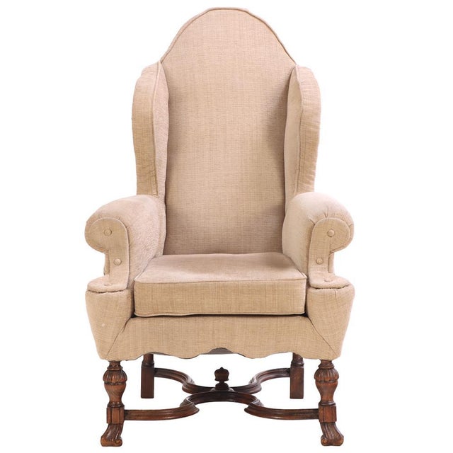 With a high arched back and out-curved arms on turned and reeded legs, joined by scrolled stretchers and terminating with...