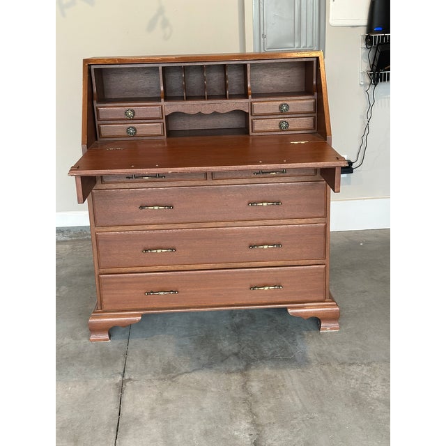Elegant vintage mahogany secretary desk with beautiful wood grain and timeless craftsmanship. Features a fold-down writing...