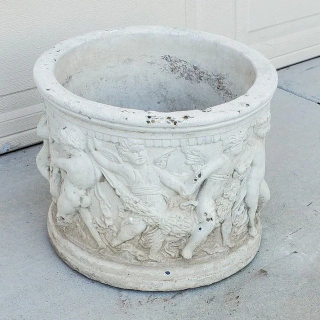 This antique Italian style planter features a beautiful relief design of a wreath of cherubs, perfect for any room or...