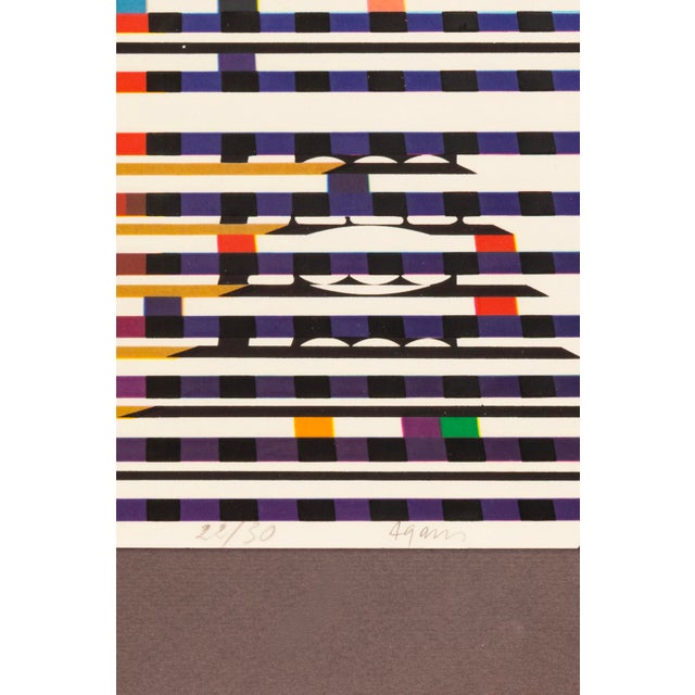 A dynamic serigraph titled "Colorful Polygraph" by pioneering kinetic and optical artist Yaacov Agam. Hand signed in...