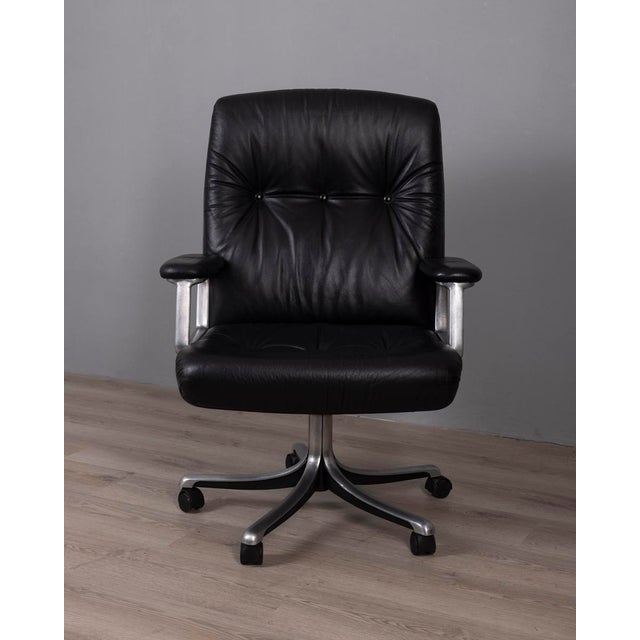 Swivel office chair with cast aluminum frame and black leather upholstery, model "P128", designed by Osvaldo Borsani for...