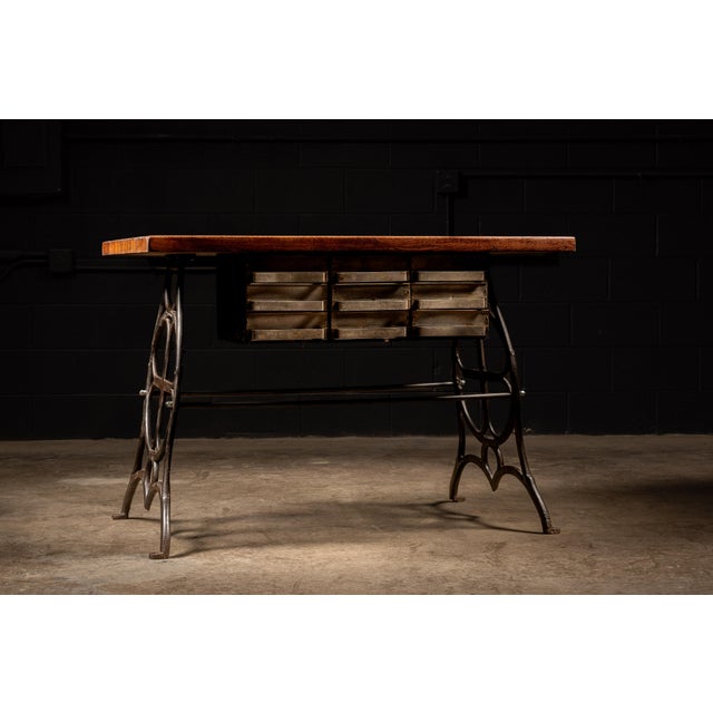 A butchers block table that has been completely refinished and attached to ornate cast iron legs. Truss rods have been...