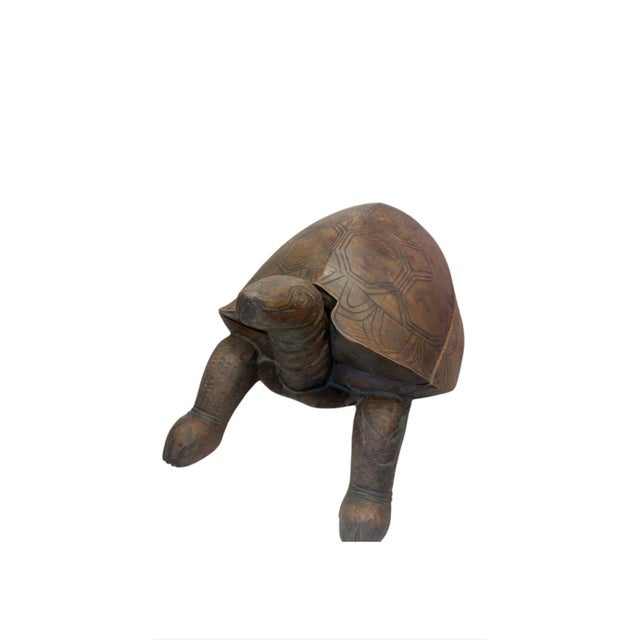 This carved wooden tortoise sculpture brings organic texture, artisanal craftsmanship, and a touch of whimsical...