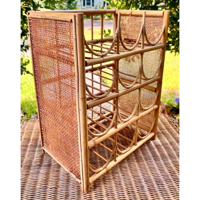 a vintage 1960s wine rack built for twelve bottles. stands sturdy and tall. made of bamboo rattan with side caning panels....