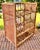 a vintage 1960s wine rack built for twelve bottles. stands sturdy and tall. made of bamboo rattan with side caning panels....