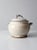 This is a vintage studio pottery tureen. The hand-crafted covered bowl features a white glaze with blue twisted handles on...