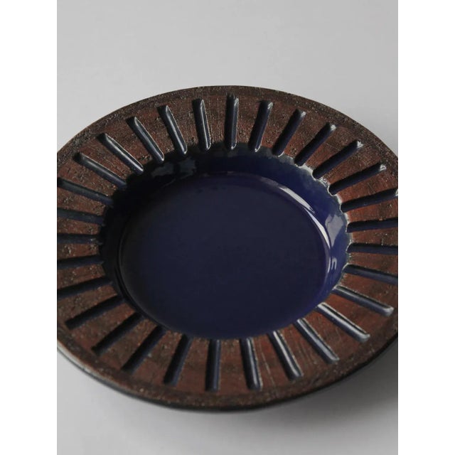 Decorative ceramic vintage plate with ethnic motifs, designed in 1960s by Ingegärd Burmeister for Gabriel Keramik. This...