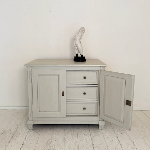 A charming German painted cabinet dating from around 1860, featuring an unusual arrangement of three drawers concealed...