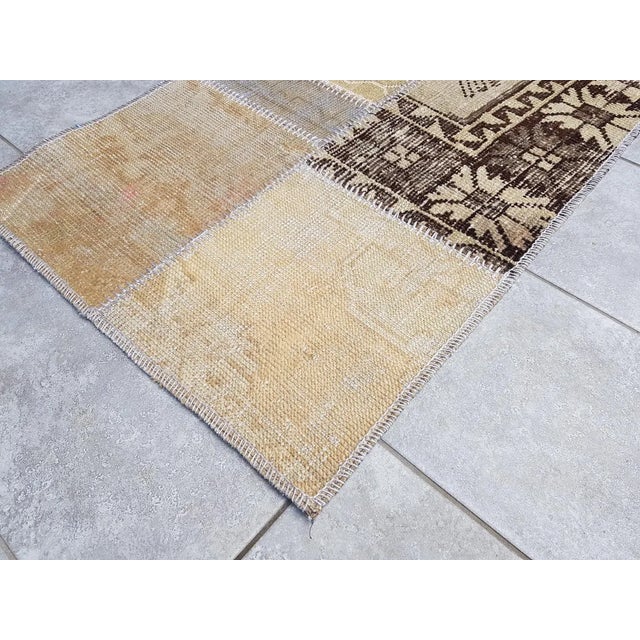 This is a vintage Turkish Oushak rug from the Mid 20th Century. The piece was hand-knotted.