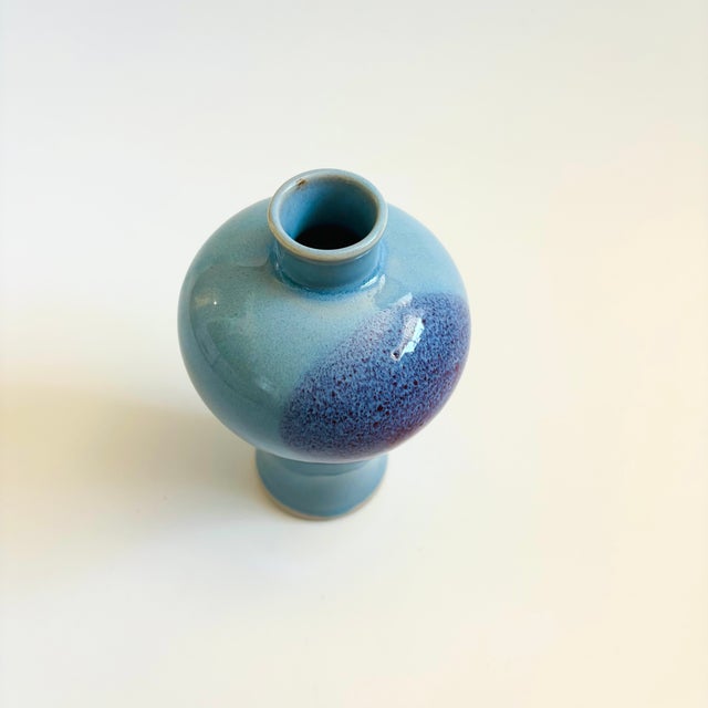 A vintage ceramic vase with a lovely blue and purple glaze.