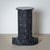 Black marble column in a stepped design with a round base. Carlo Scarpa designed this series in 1970 for the Italian...