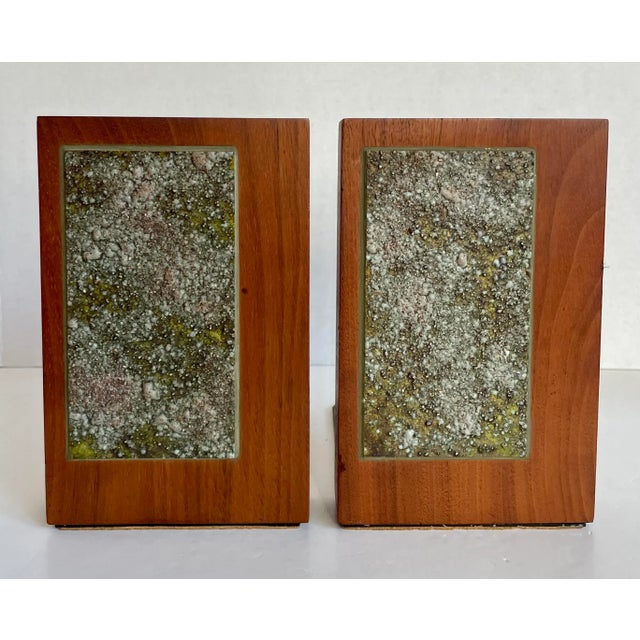 Here is a fantastic pair of solid wood bookends with artist signature from the mid-century. The bookends feature a...