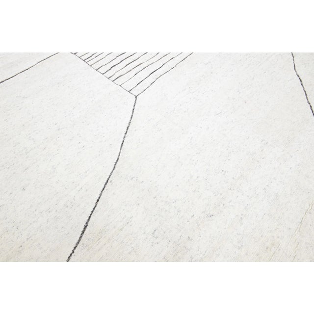 Beautiful modern Moroccan-style hand-knotted wool rug with an ivory color field. This rug is part of our Apadana's Safi...